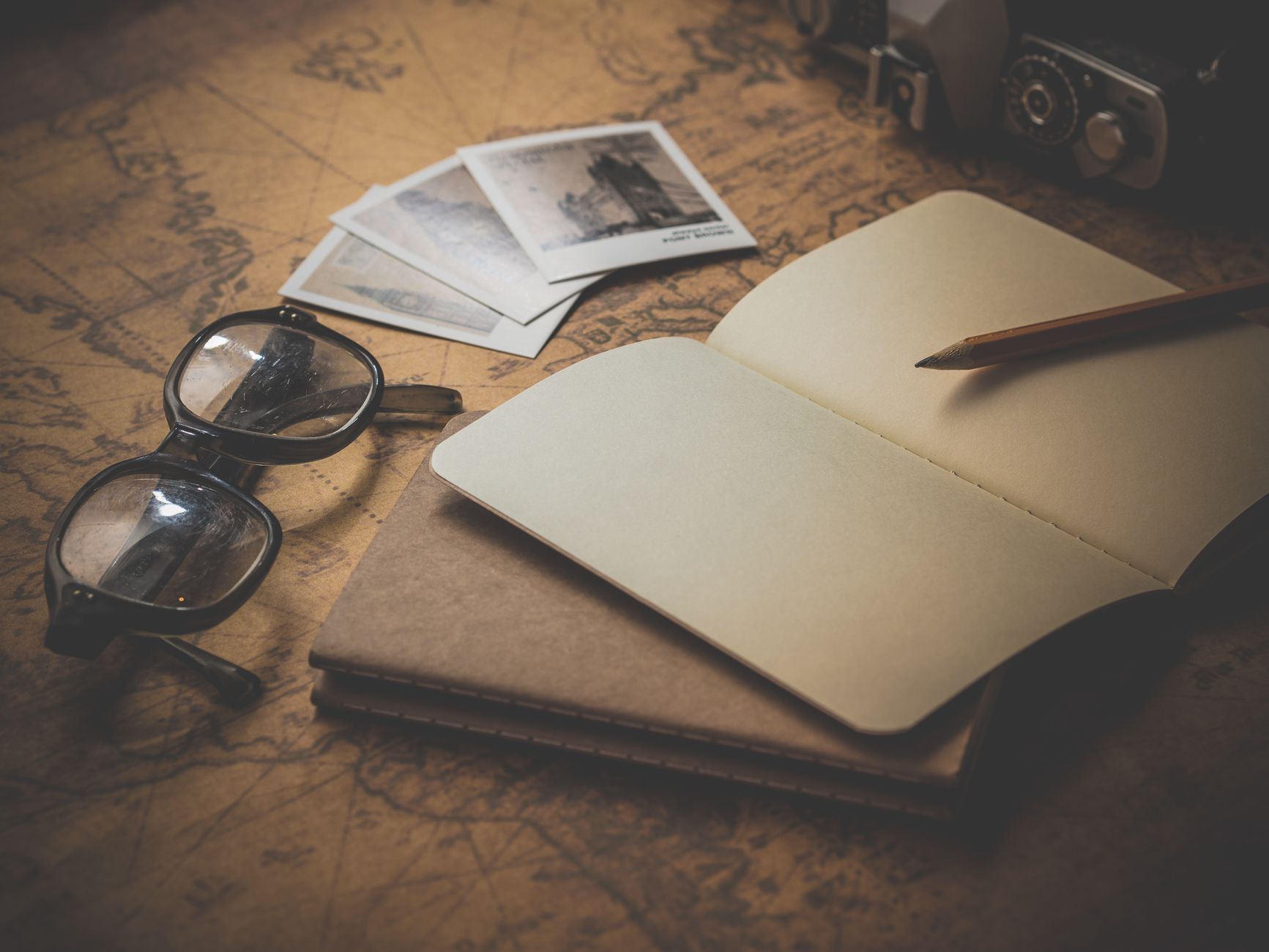 Editorial archival materials and vintage maps on desk